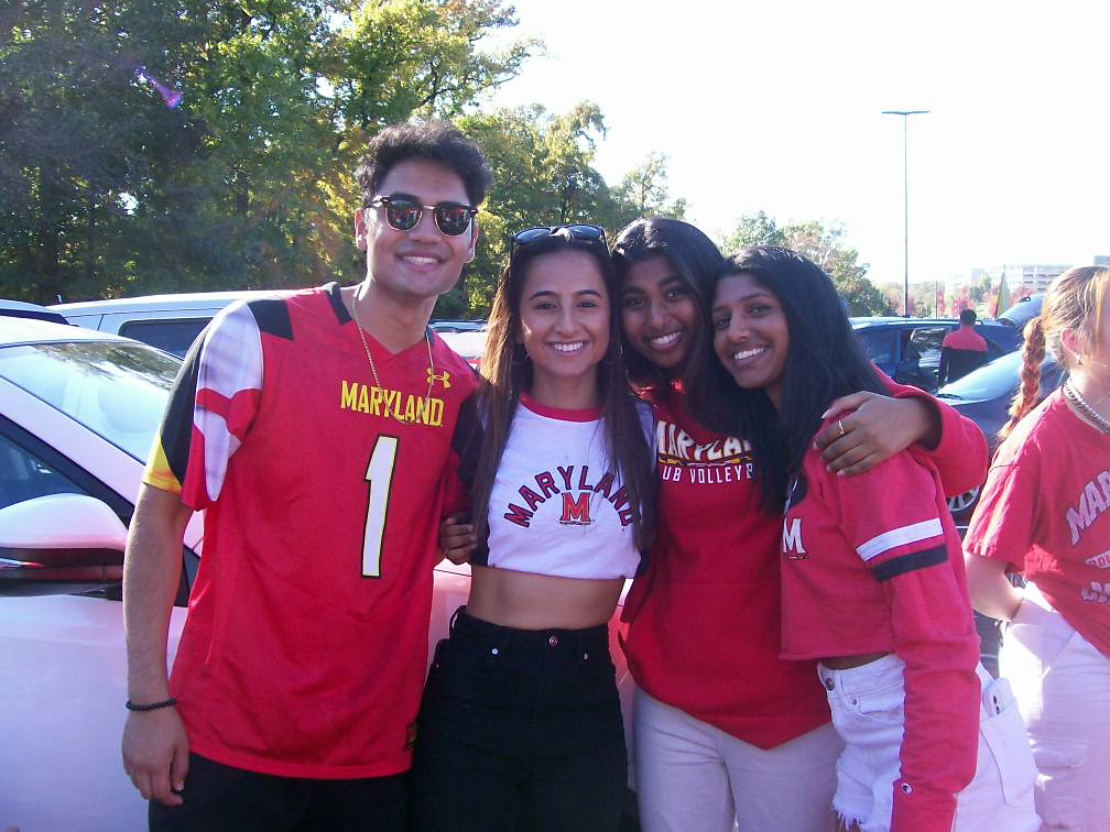 A group of four HPAO students at a UMD sporting event.